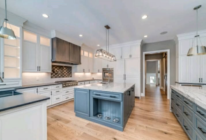Custom kitchen with large island and hardwood floors
